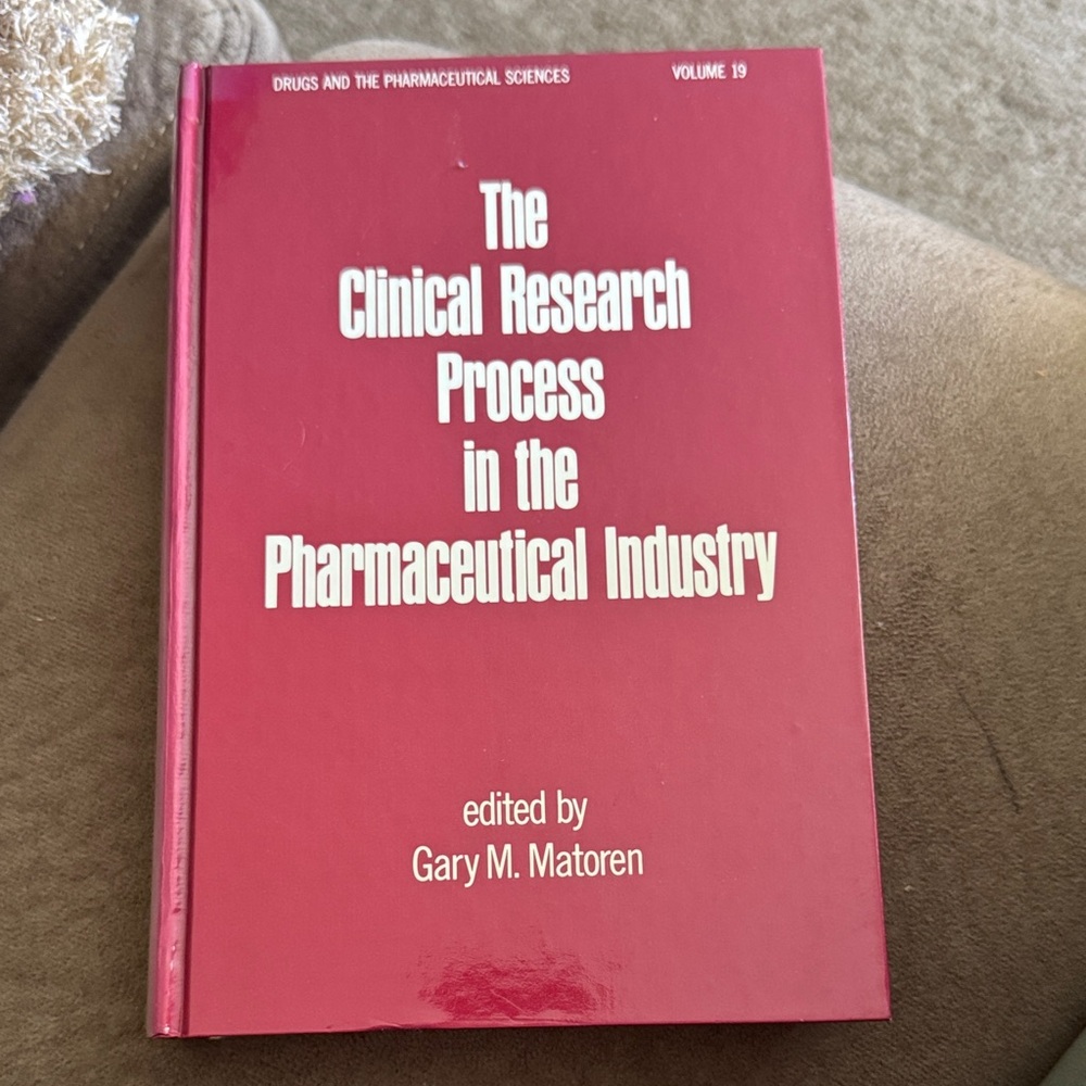 Red Hardcover Book on Clinical Research